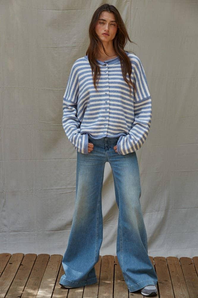 Woman in blue and white striped cardigan with wide-leg jeans, coastal PNW style