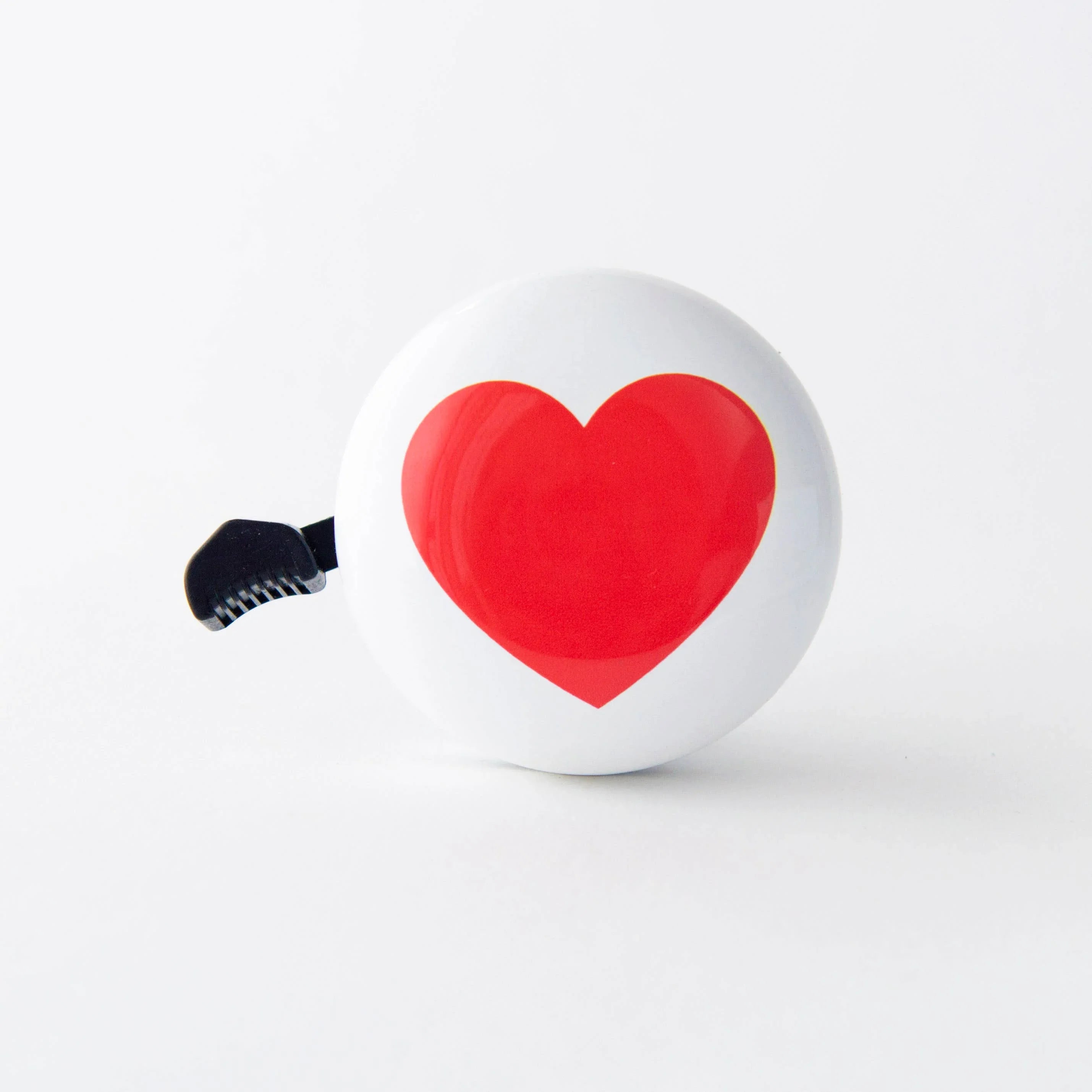 White bike bell with red heart design, perfect for coastal bike rides and outdoor adventures