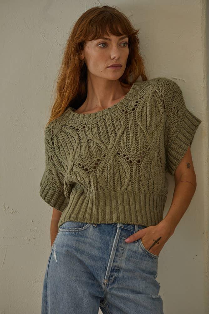Olive green cable knit sweater with short sleeves, worn with blue jeans, casual women's fashion
