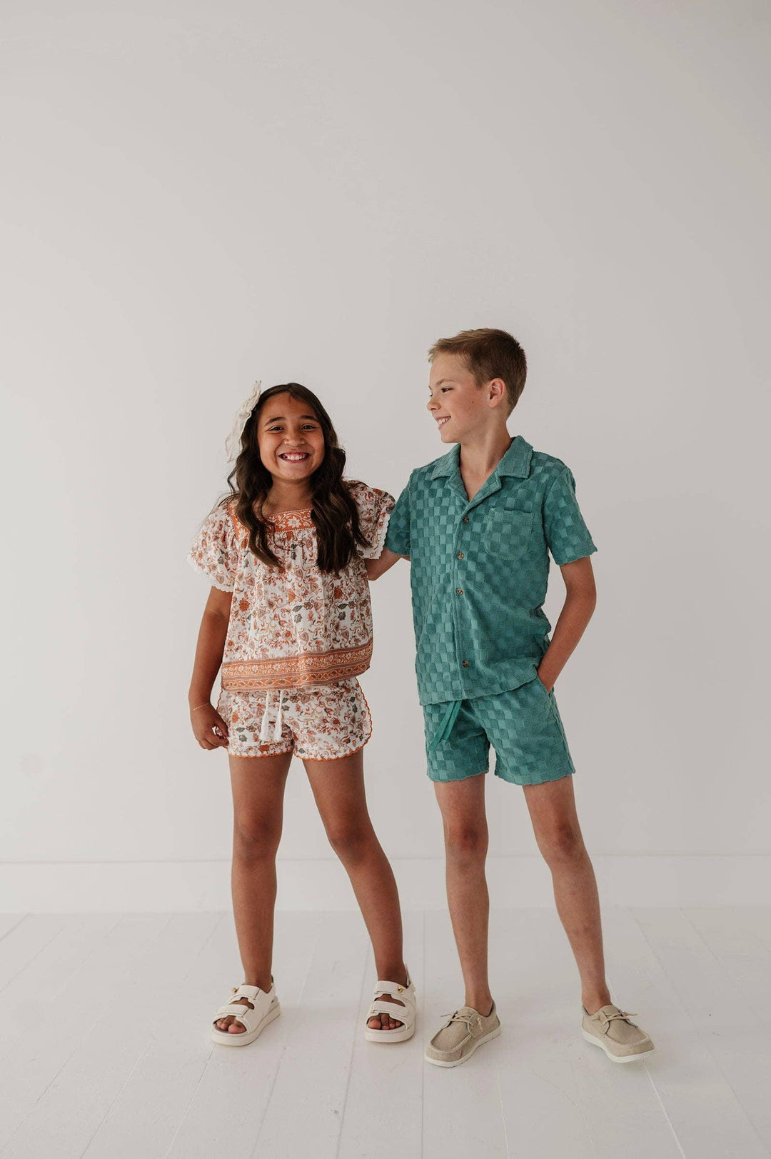 Kids in matching floral and checkered short sets for coastal summer adventures
