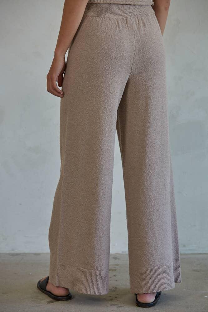Beige wide-leg knit pants with elastic waist, styled for coastal PNW comfort and everyday adventure.