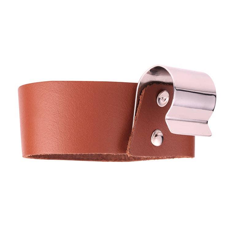 Brown leather bike handlebar grip with silver metal clamp for coastal adventures
