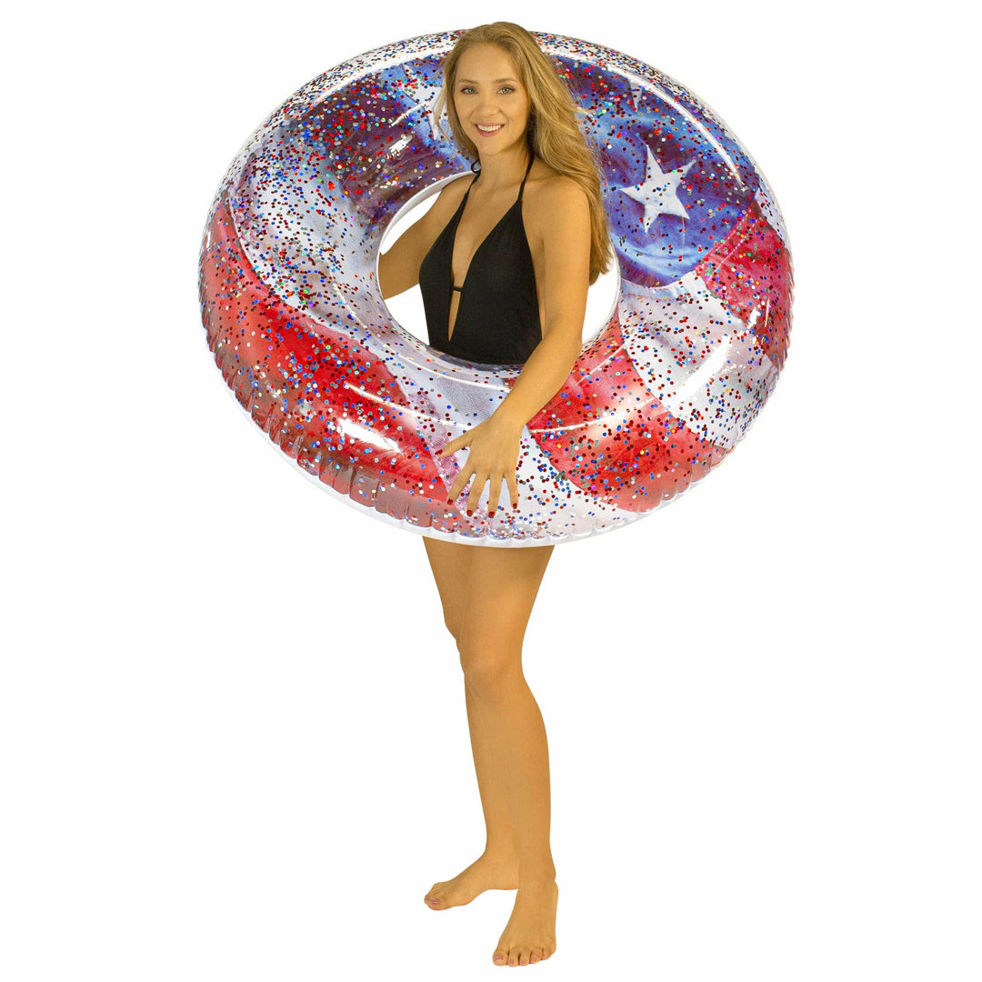 Woman holding red, white, and blue glitter inflatable pool float with star design for beach or pool fun