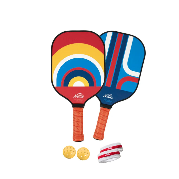Colorful Nettie pickleball paddles with balls and wristbands, perfect for outdoor fun and coastal adventures.