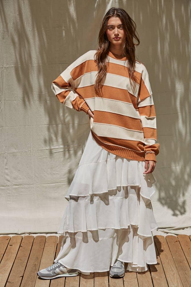 Striped orange and cream sweater with tiered white skirt, coastal outdoor style