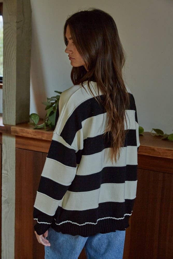 Woman wearing black and cream striped oversized sweater, coastal style, PNW weekend ready