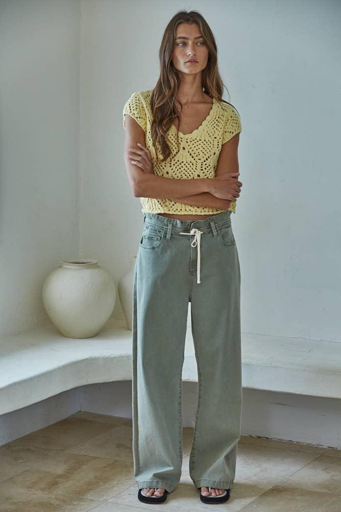 Woman in yellow crochet top and wide-leg jeans, casual summer outfit
