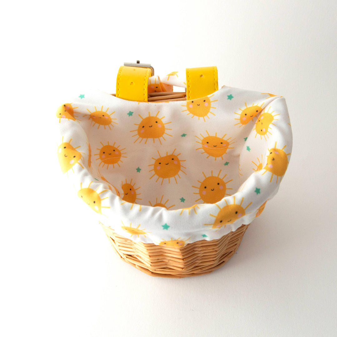 Wicker bike basket with cheerful sun print liner, perfect for coastal adventures and everyday PNW style.