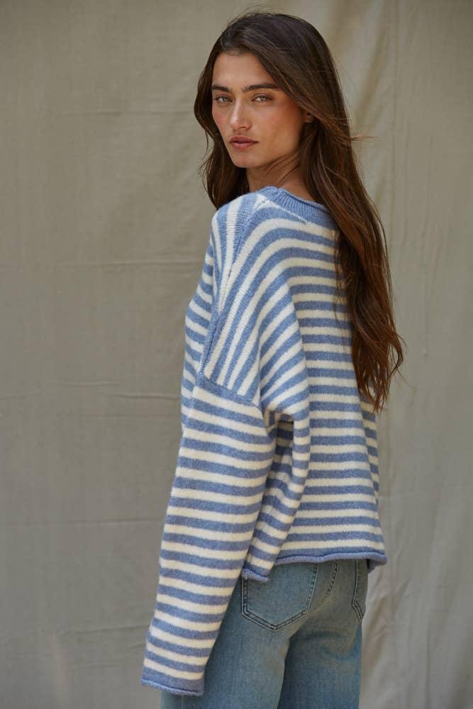 Woman in blue and white striped cozy sweater, coastal style outfit