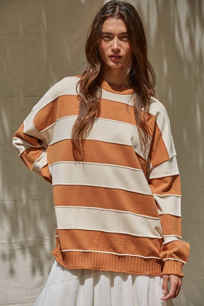 Oversized striped sweater in rust and cream, coastal style for PNW adventures