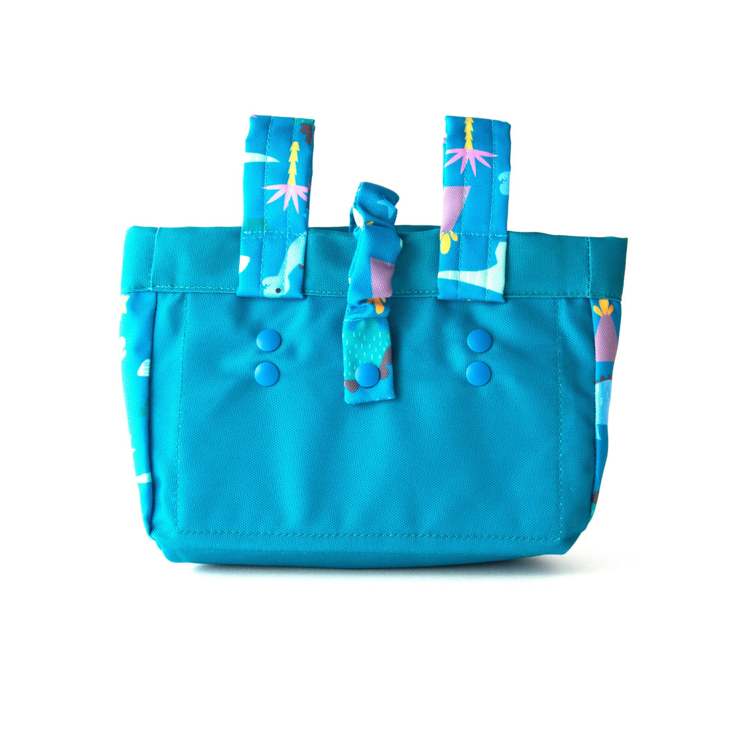 Blue patterned tote bag with whale and palm tree print, perfect for beach days and coastal adventures.