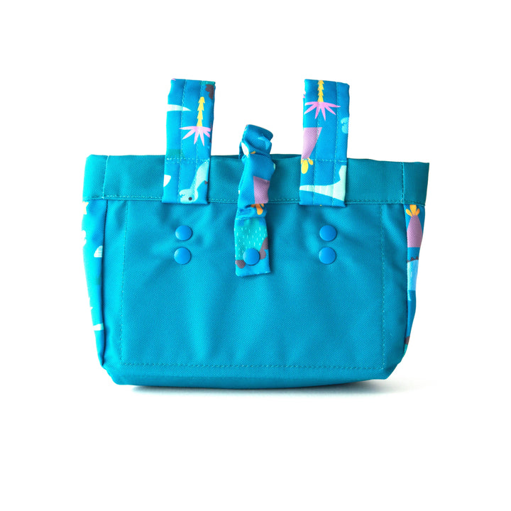 Blue patterned tote bag with whale and palm tree print, perfect for beach days and coastal adventures.