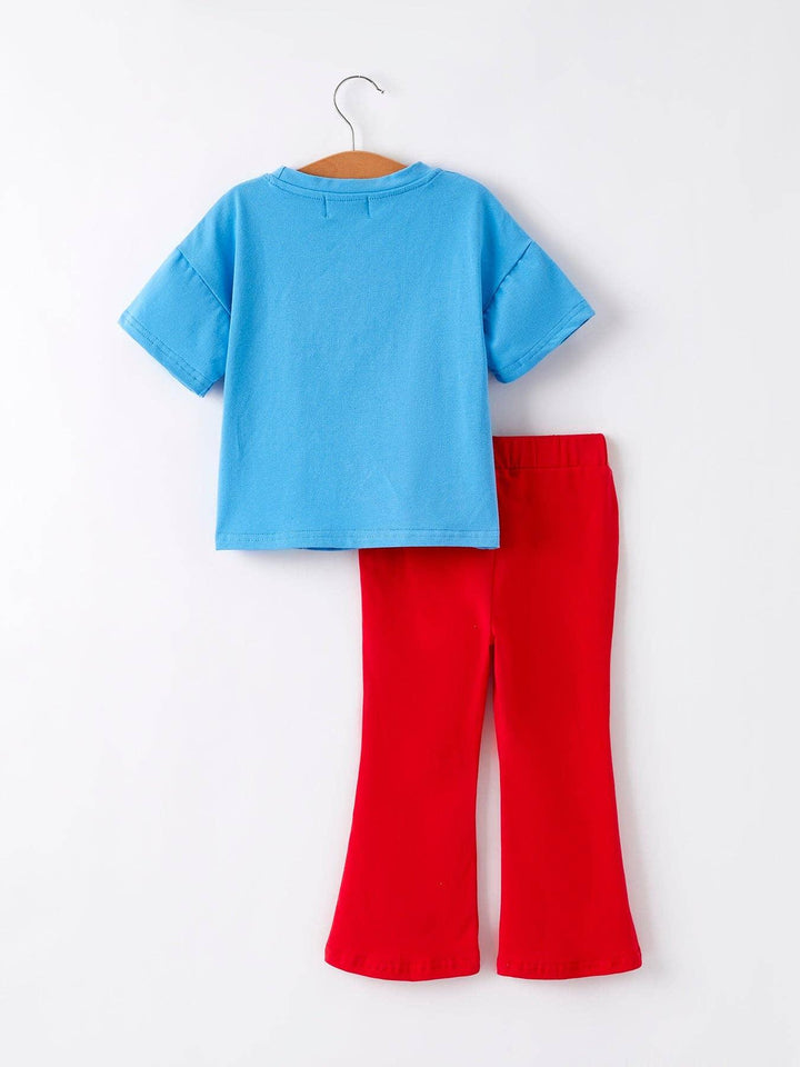 Blue kids tee and red flared pants set on hanger, casual coastal outfit for playdays