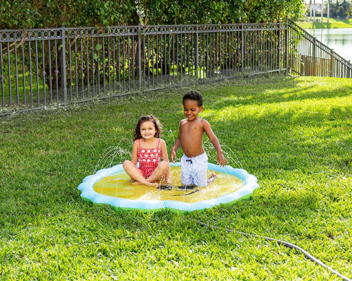 Kids playing in backyard splash pad on sunny day, perfect for outdoor summer fun and family backyard activities.