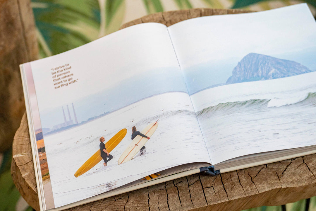 Open book showing surfers with boards on beach, coastal adventure lifestyle