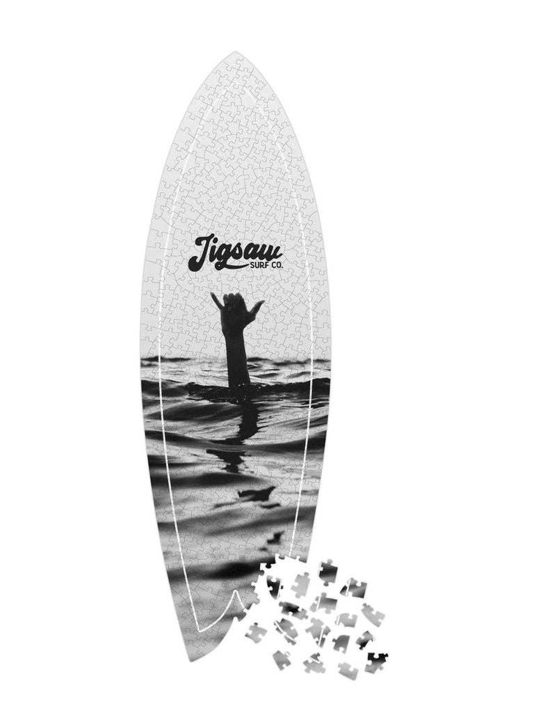 Surfboard puzzle with Jigsaw Surf Co. logo and ocean hand wave design