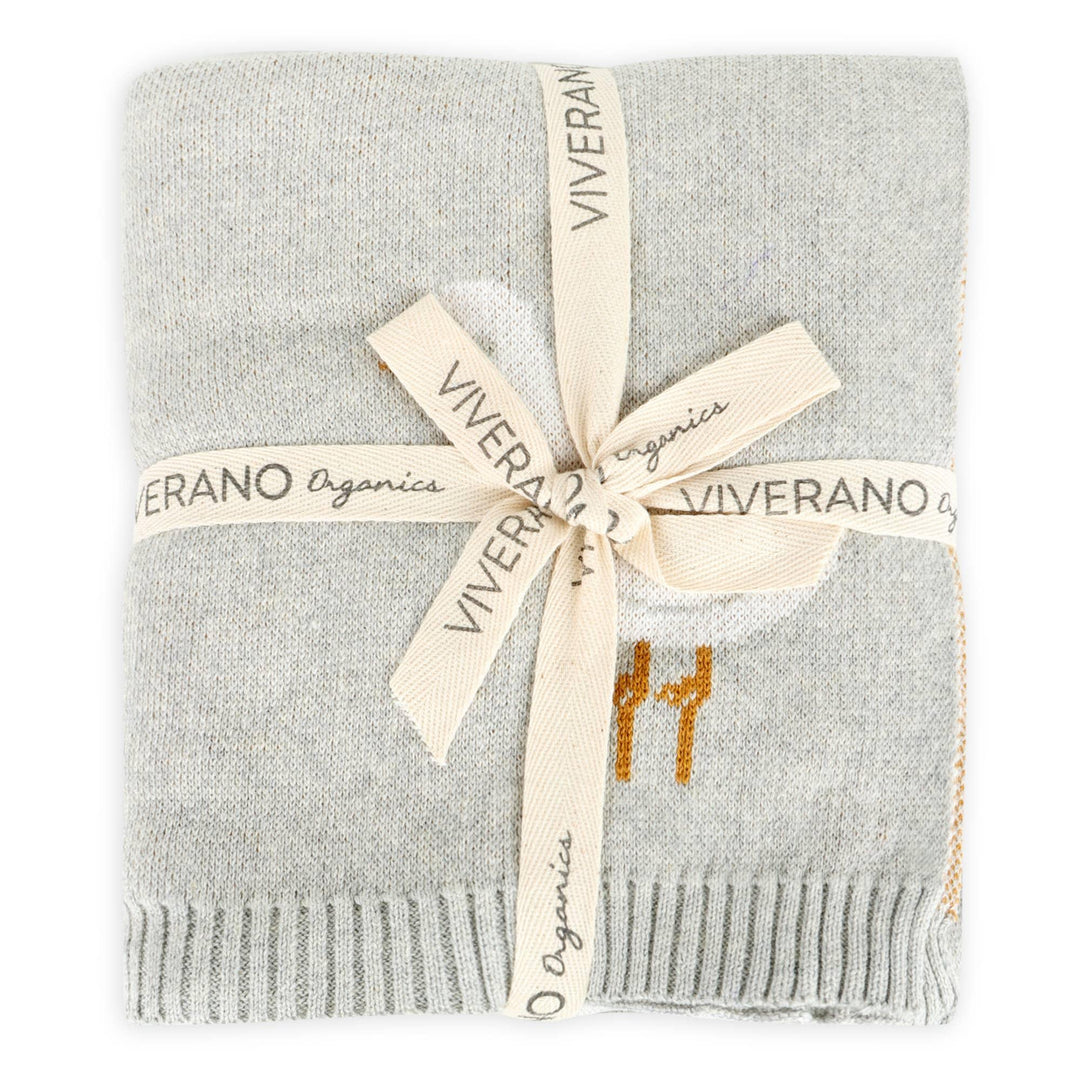 Soft gray Viverano Organics baby blanket with orange giraffe print, tied with branded ribbon