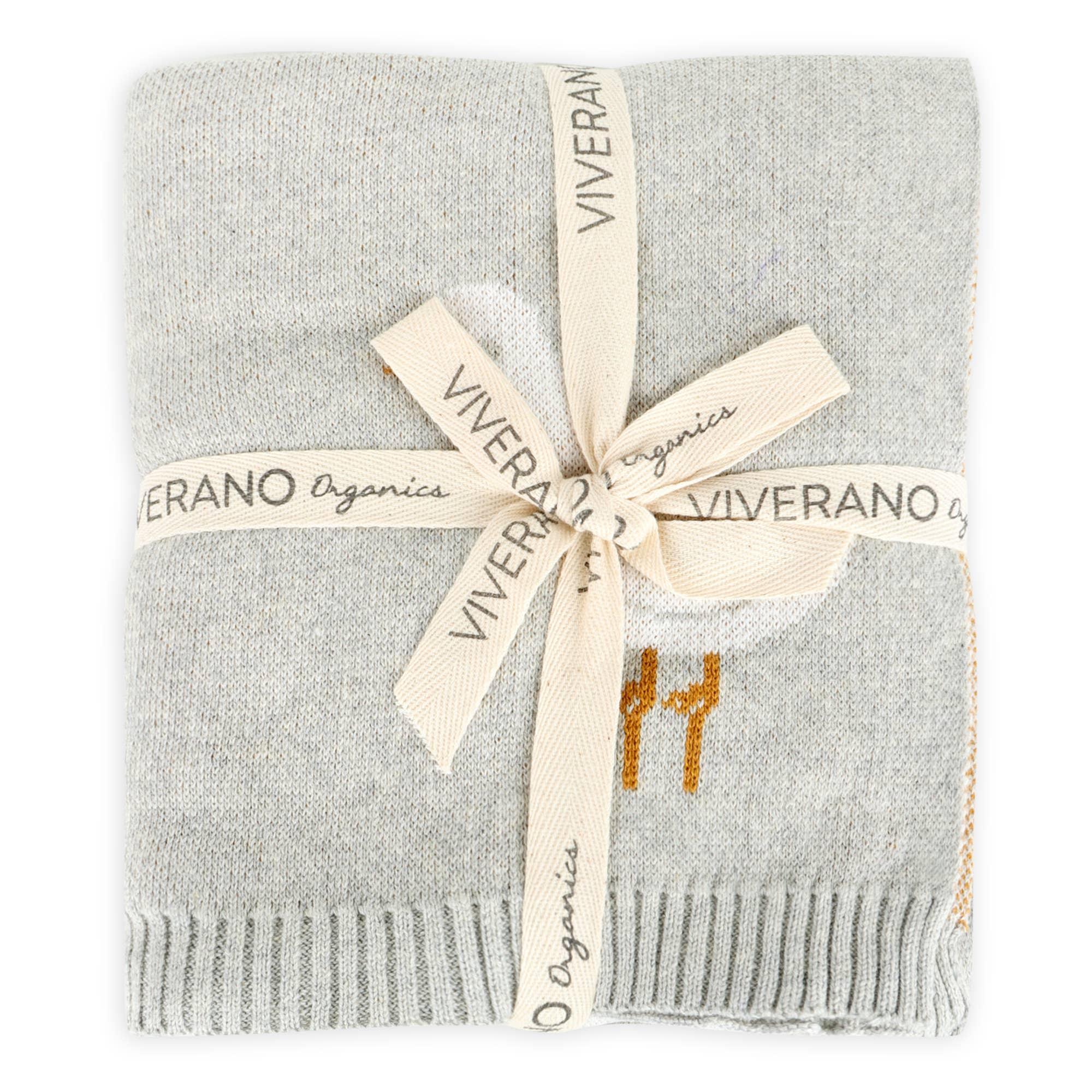 Soft gray Viverano Organics baby blanket with orange giraffe print, tied with branded ribbon