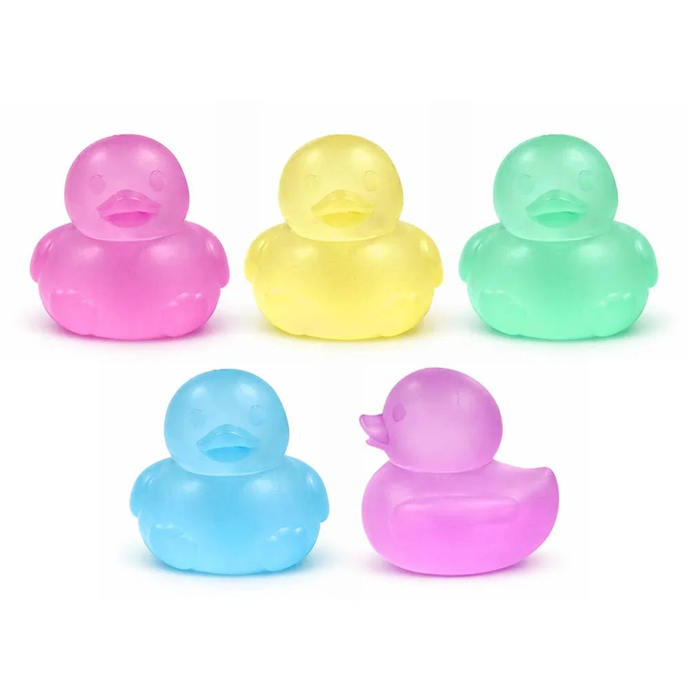 Set of five colorful translucent rubber ducks in pink, yellow, green, blue, and purple for bath or beach play