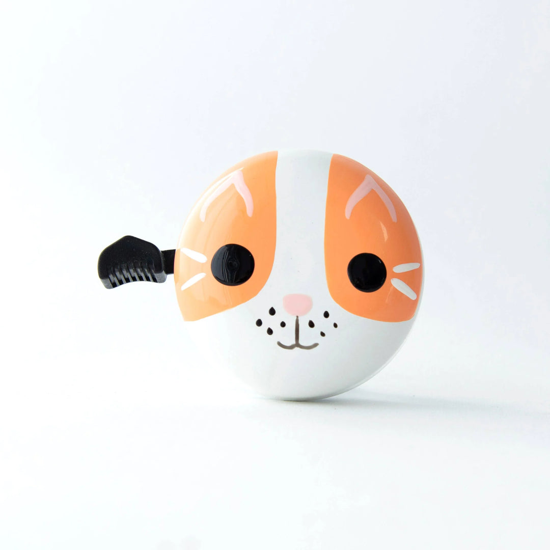 Cute orange and white cat face bike bell with black lever, perfect for coastal adventures and bike rides.