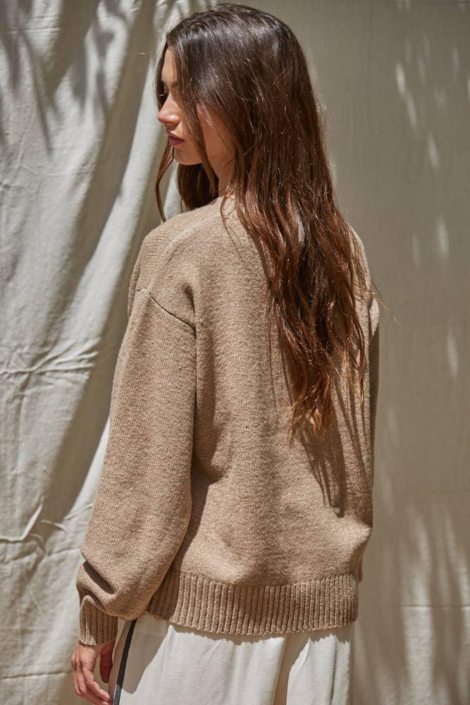 Cozy beige knit sweater for coastal PNW style, perfect for beach days and everyday adventures.