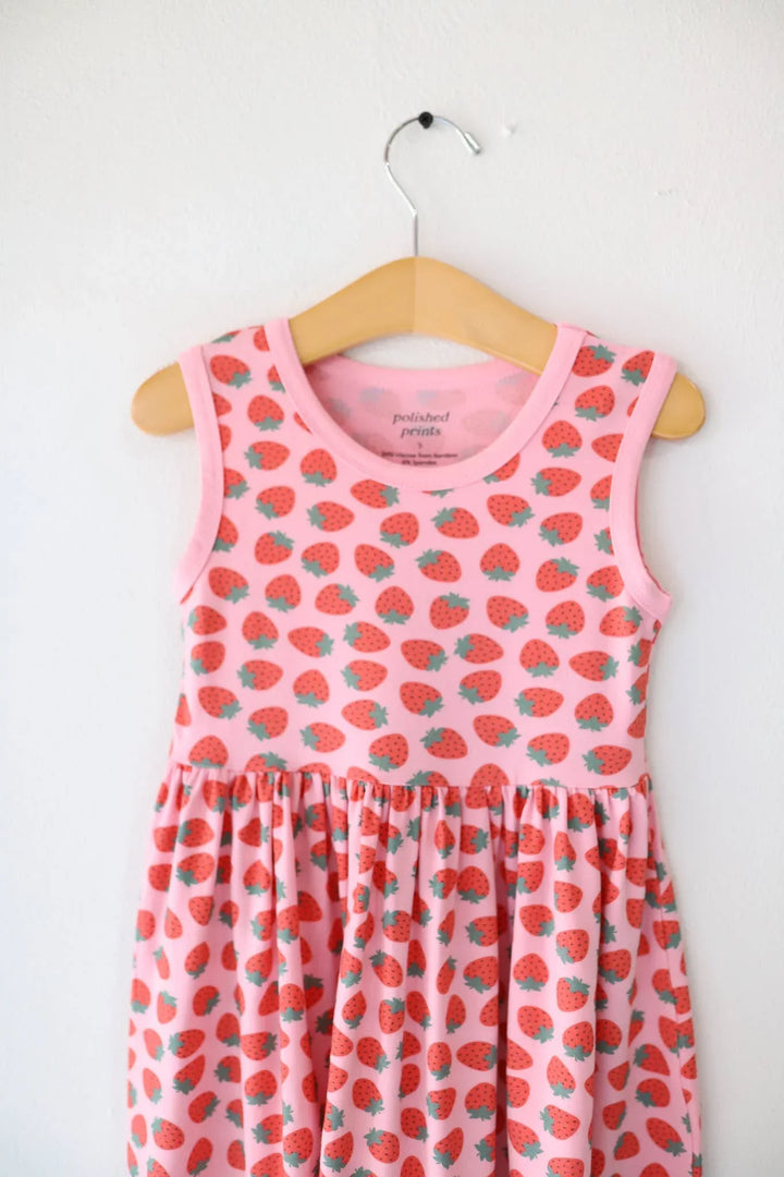 Pink strawberry print sleeveless dress for kids, perfect for beach days and coastal adventures