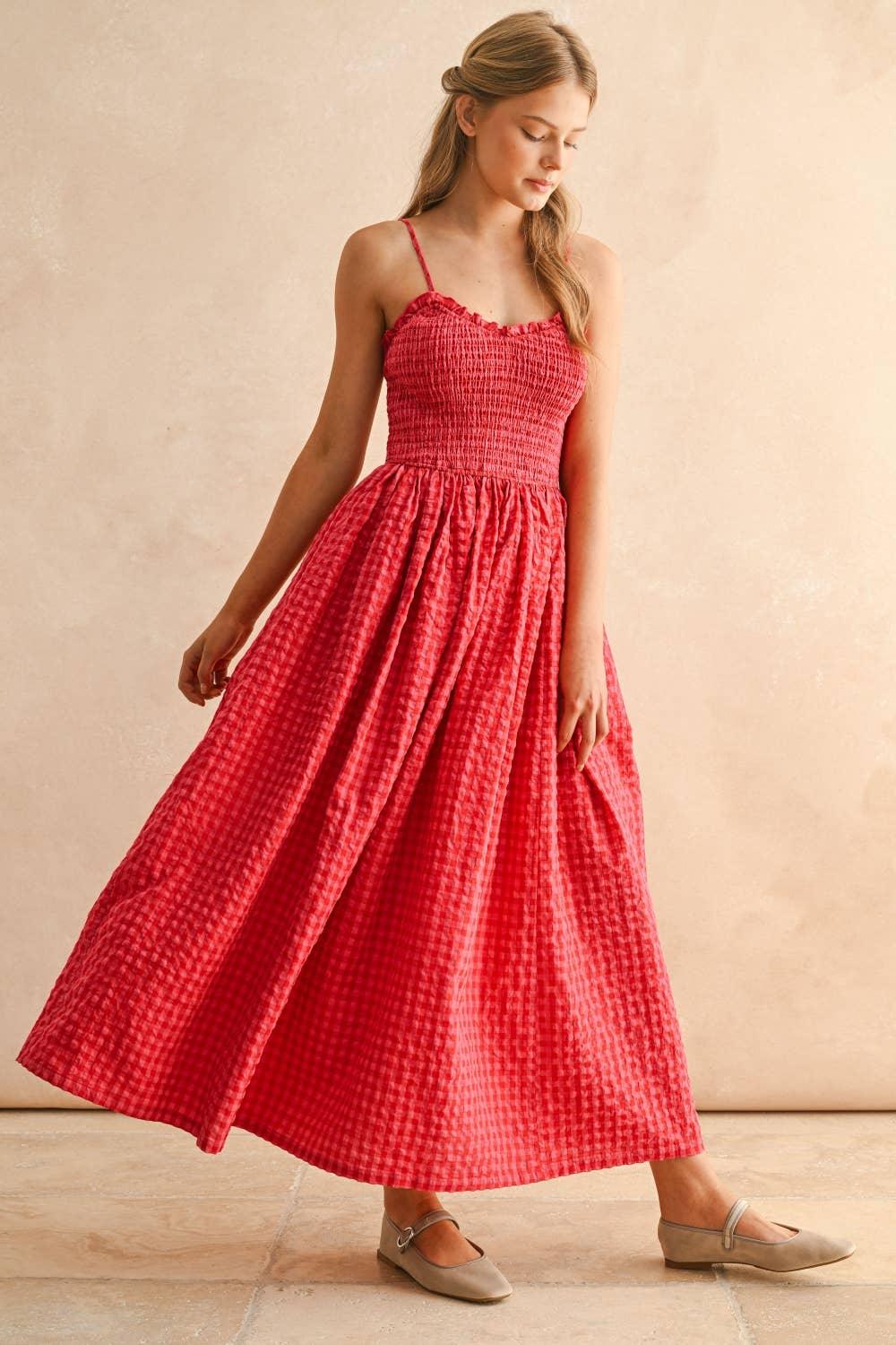 Red gingham maxi dress with smocked bodice and thin straps, styled with neutral flats