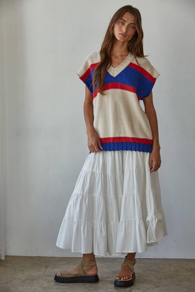 Woman in striped knit top and white tiered skirt, coastal style outfit for beach days and PNW adventures