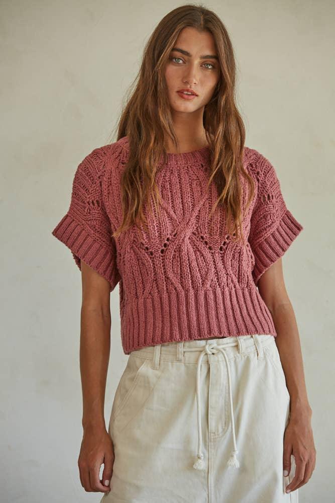 Pink cable knit cropped sweater with short sleeves, paired with cream drawstring pants