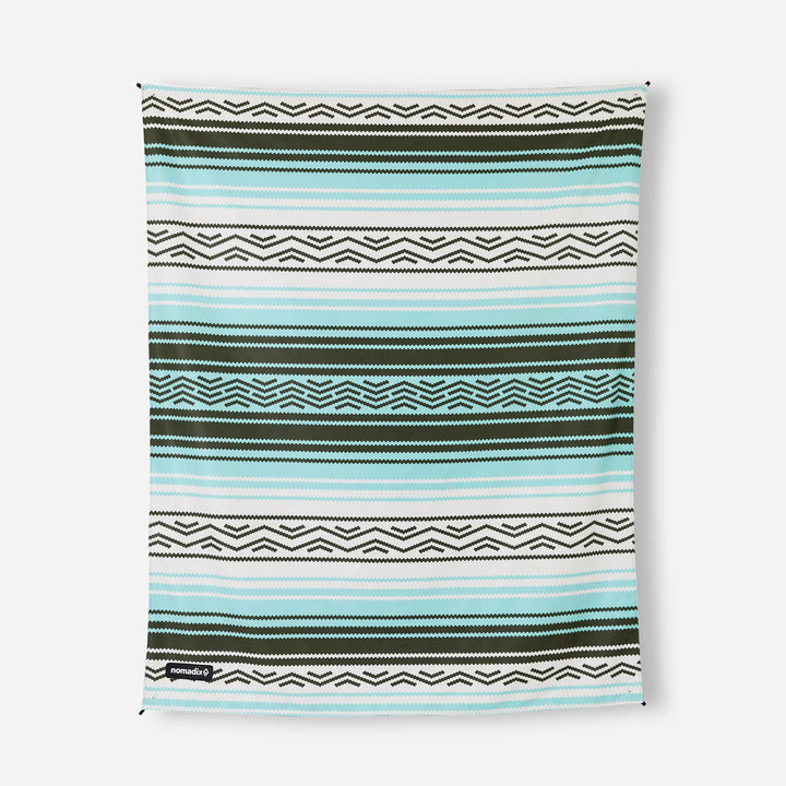 Nomadix beach towel with teal, white, and olive geometric stripes for outdoor adventures and coastal style