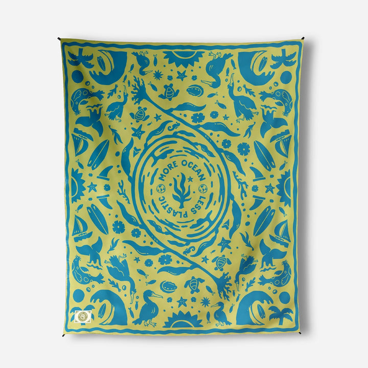Ocean-themed beach towel with sea creatures, surfboards, and &