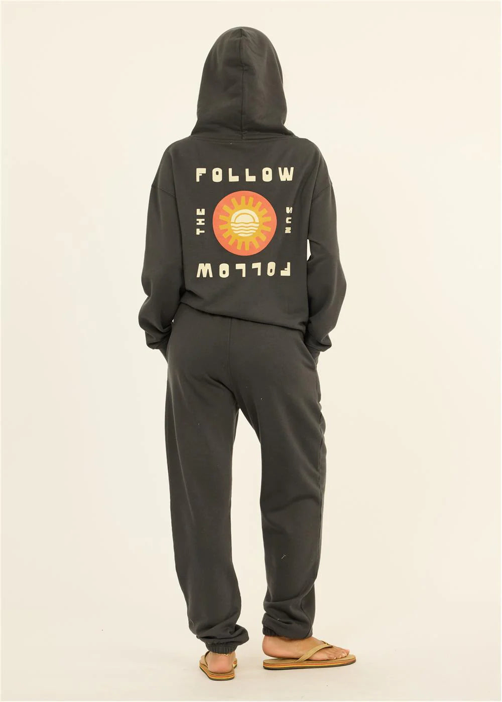 Black hoodie and joggers set with 'Follow the Sun' graphic, perfect for coastal PNW adventures and beach days.