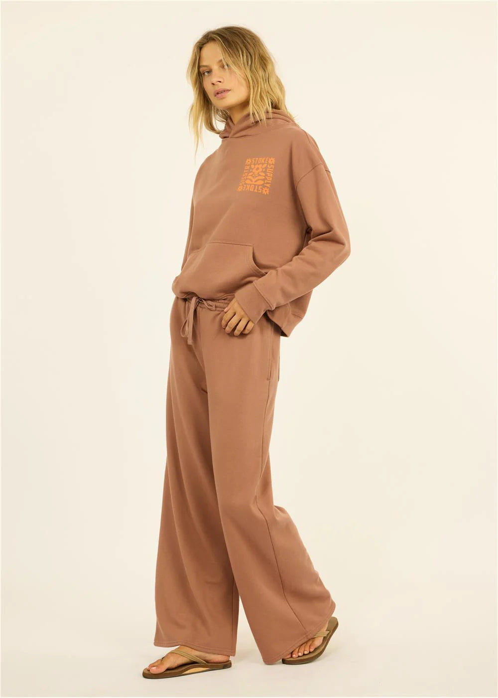 Women's cozy brown hoodie and wide-leg sweatpants set with orange graphic, perfect for PNW coastal style