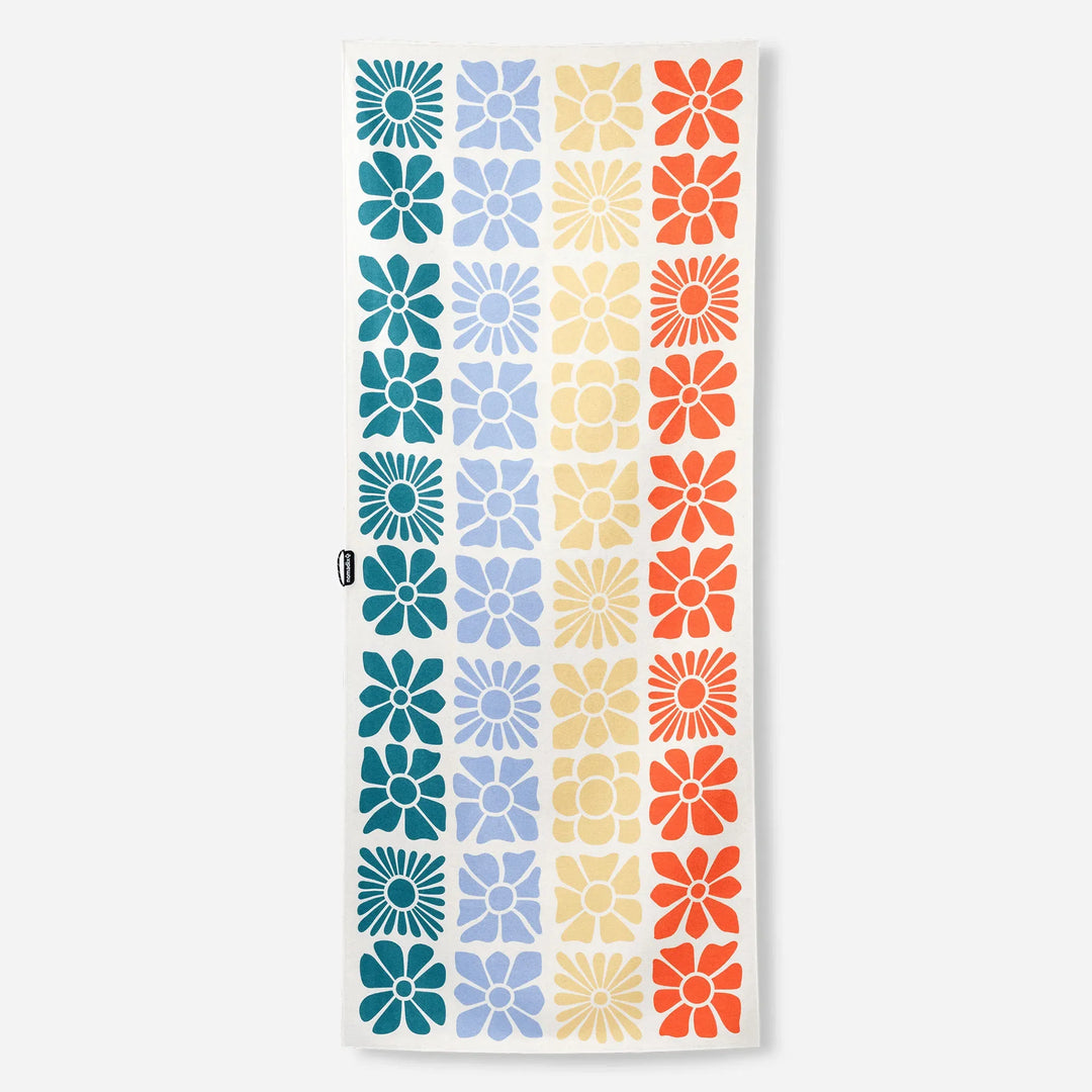 Colorful floral pattern beach towel with retro daisy design in blue, yellow, and orange stripes