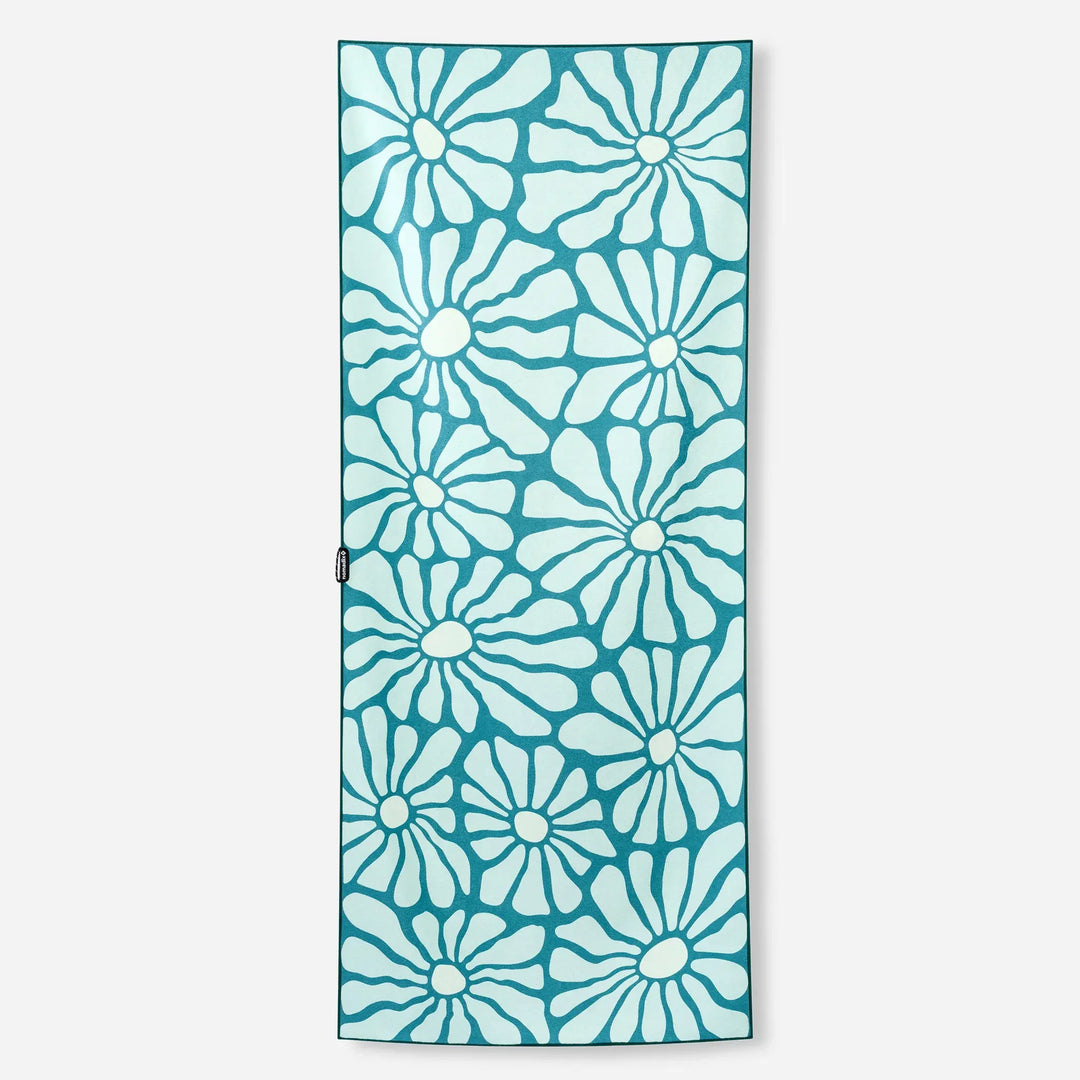 Teal yoga mat with white floral pattern, ideal for home workouts and outdoor adventures