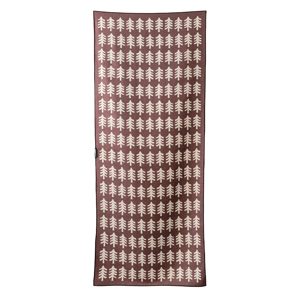 Brown beach towel with white pine tree pattern, perfect for coastal adventures and outdoor lifestyle gear.