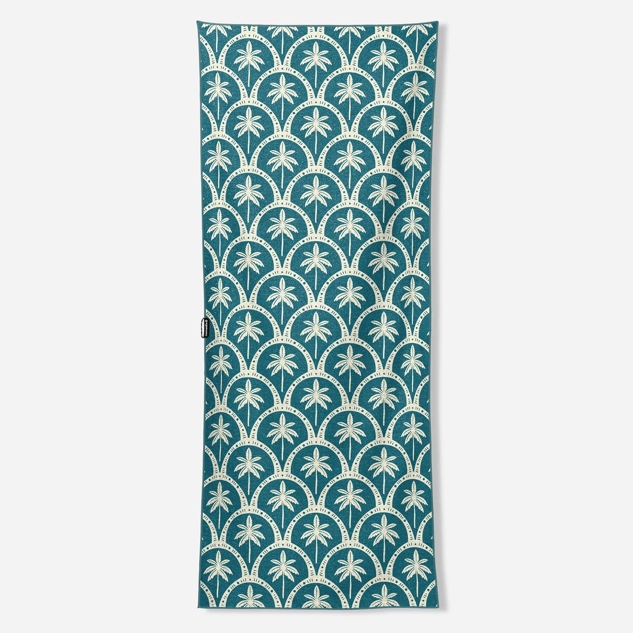 Teal beach towel with white palm tree and scallop pattern, ideal for board and bike adventures