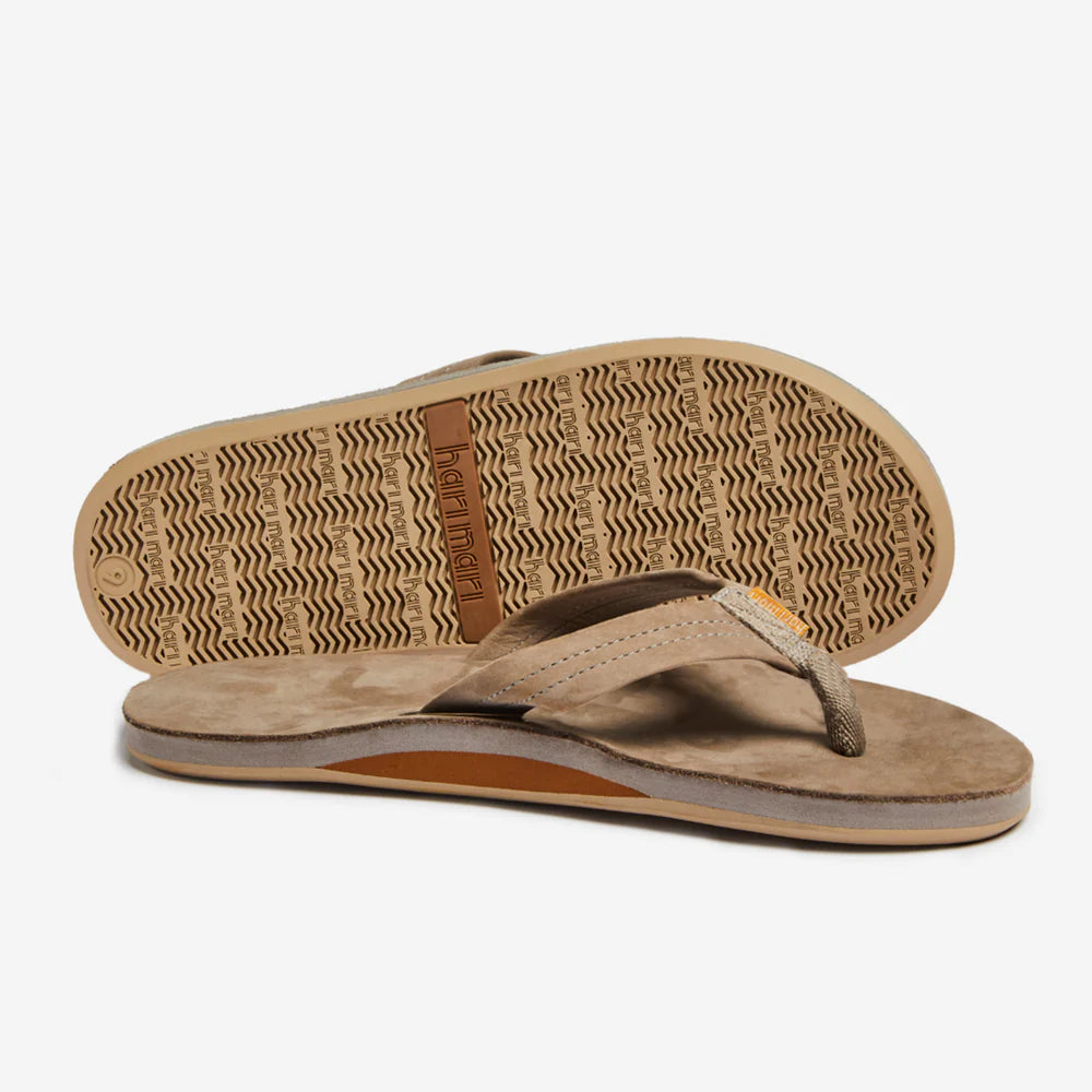 Beige flip flops with textured sole and brand logo, ideal for beach days and coastal adventures