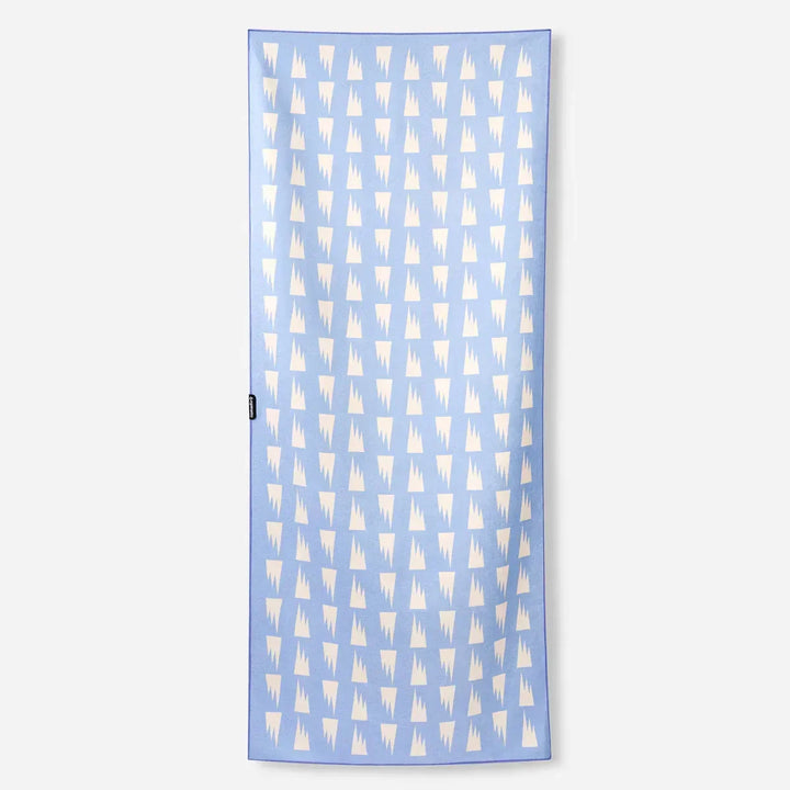 Light blue beach towel with white geometric mountain pattern, perfect for PNW coastal adventures and outdoor lifestyle.