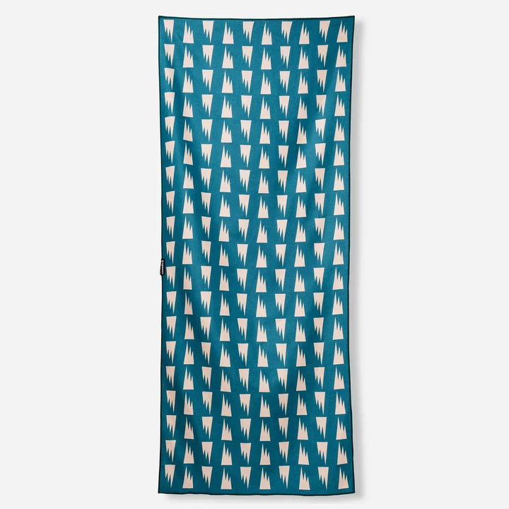 Teal beach towel with white mountain pattern, perfect for PNW adventures and coastal days