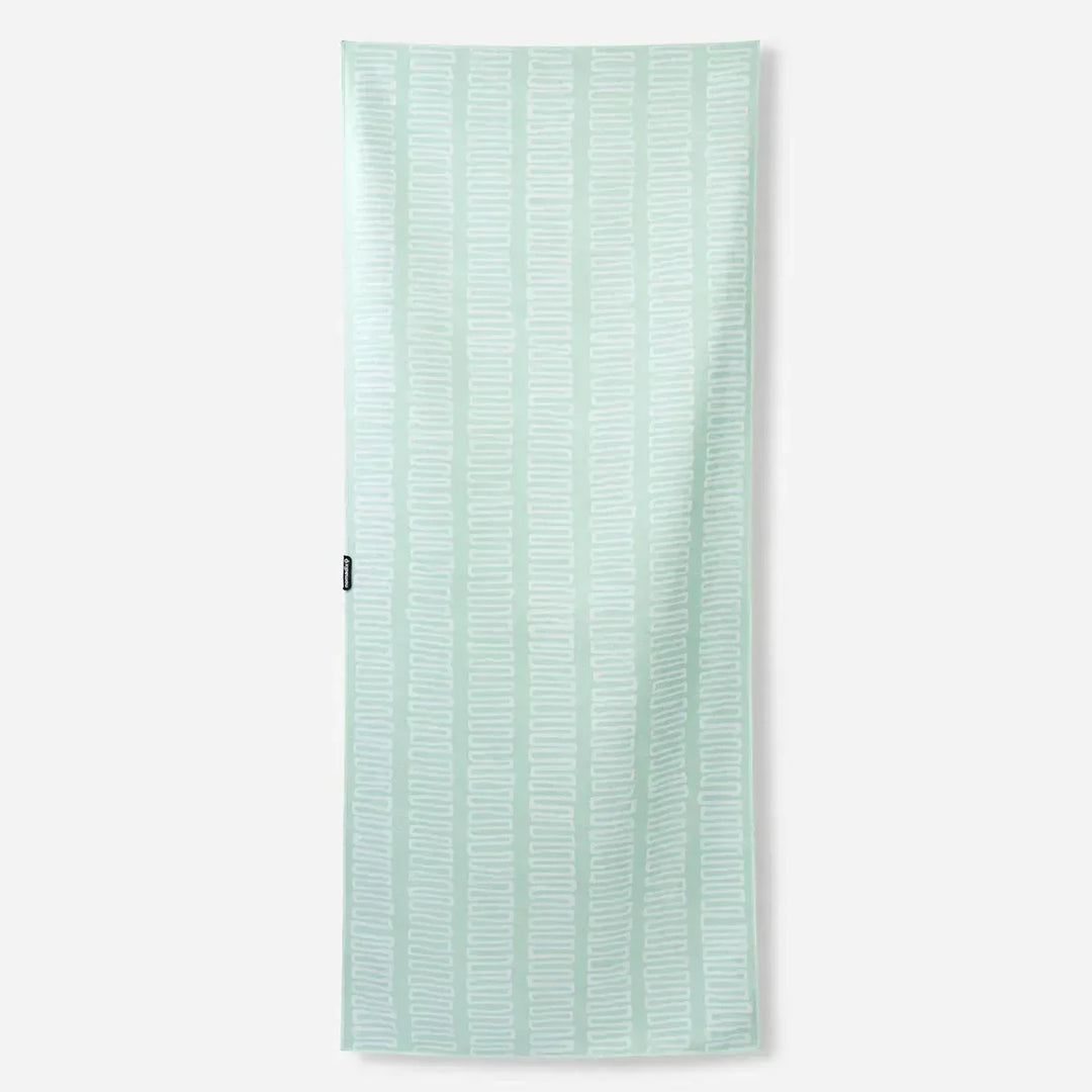 Mint green beach towel with white geometric pattern, perfect for coastal adventures and outdoor lifestyle gear.