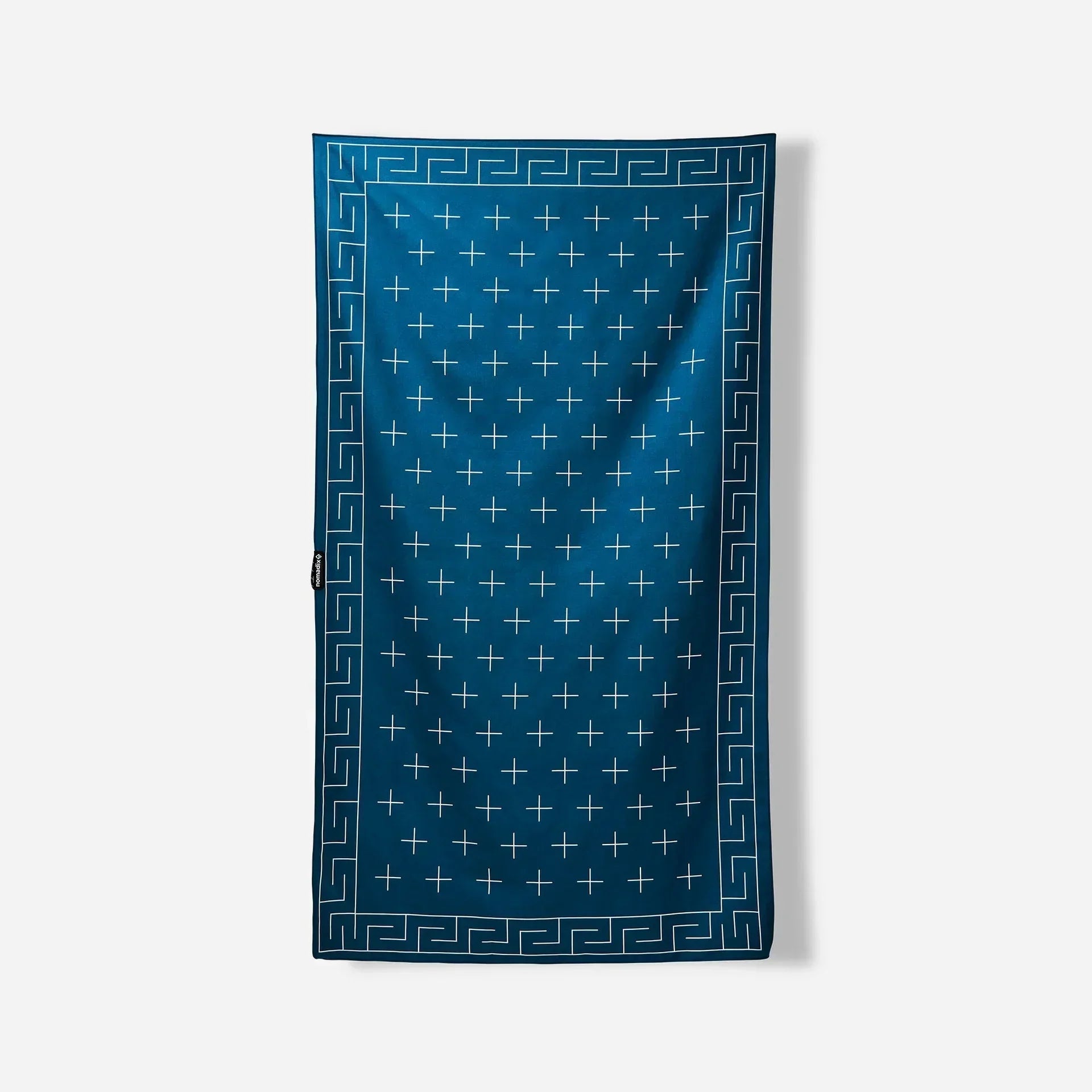 Blue beach towel with white cross pattern and Greek key border, ideal for poolside or outdoor adventures.