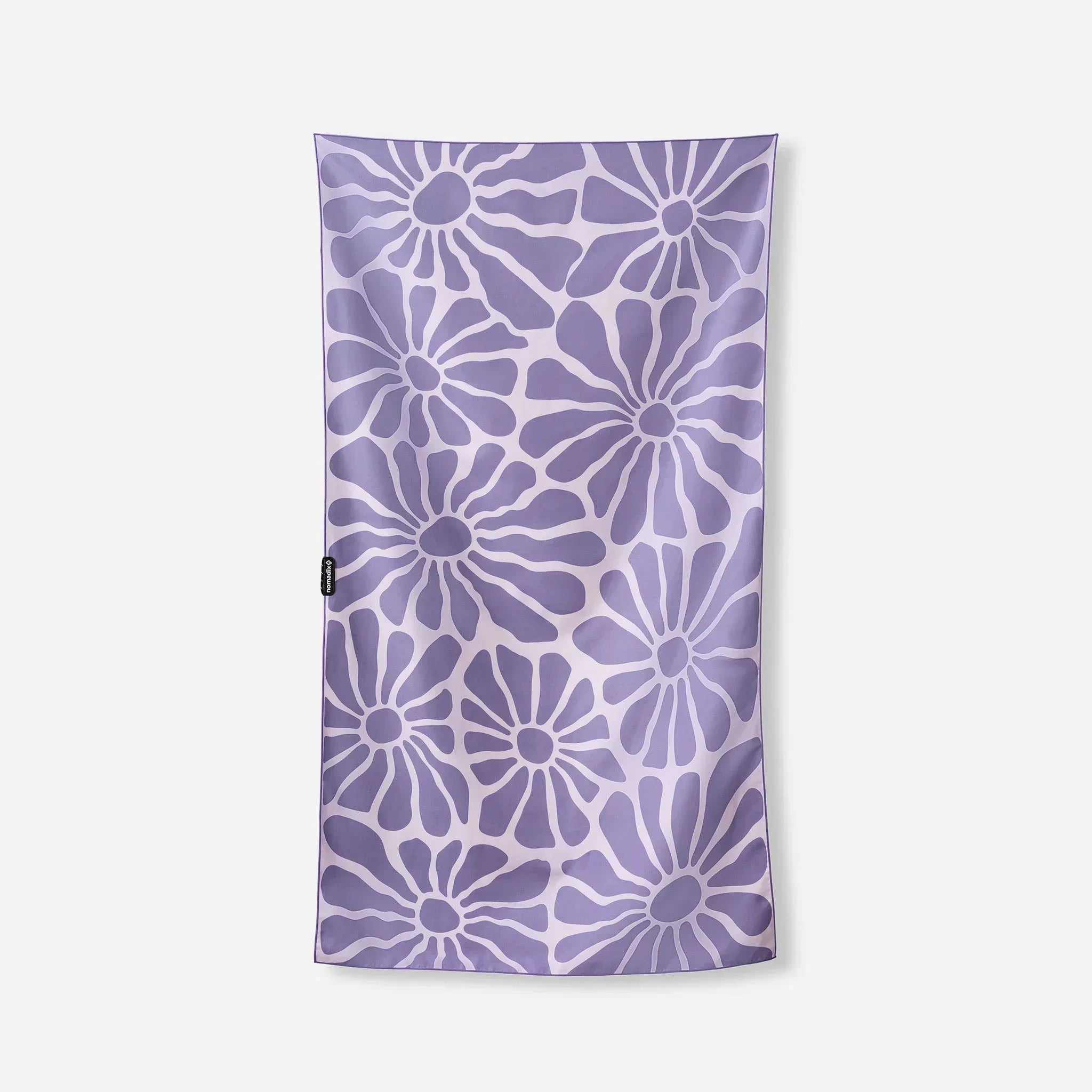 Purple floral patterned towel with white accents, ideal for beach or pool use.